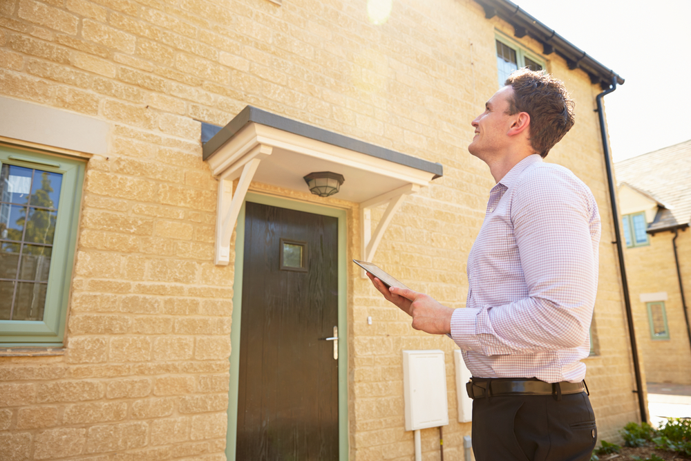 man surveying home