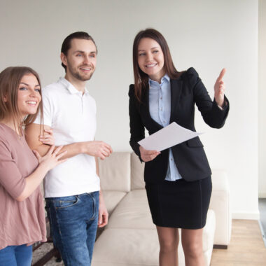 estate agent showing a property to a young couple